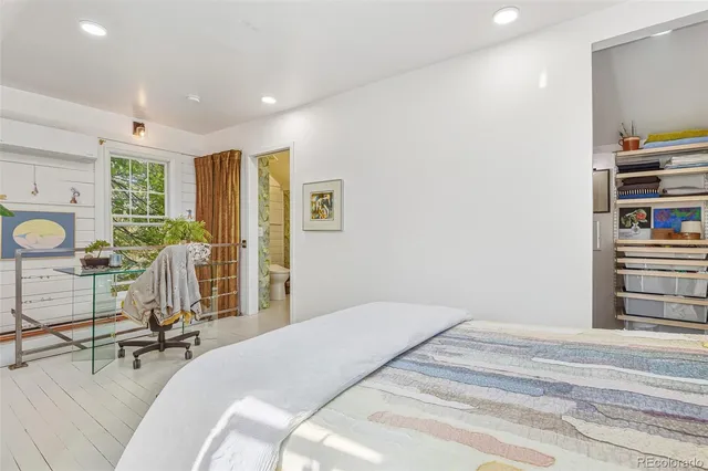 a bedroom with a bed and a potted plant