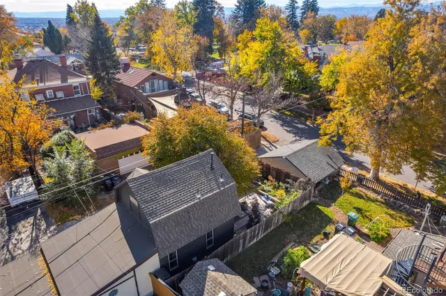 an aerial view of a house with a yard and outdoor seating