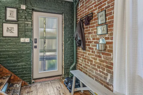 a view of a balcony with a door and wooden floor