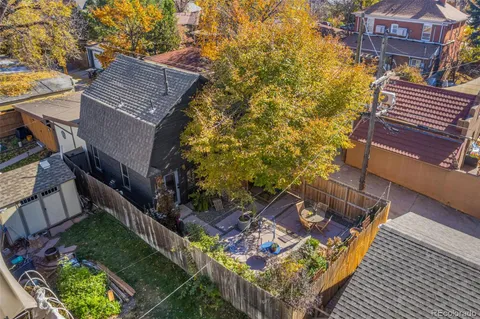 a backyard of a house with table and chairs