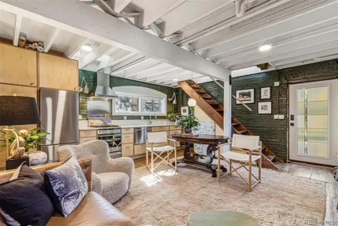 a living room with furniture a fireplace and a wooden floor
