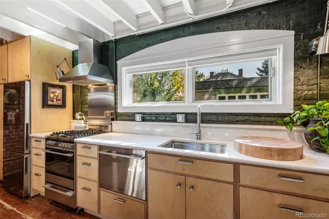 a kitchen with stainless steel appliances a sink and a stove