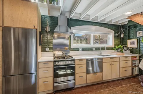 a kitchen with a stove oven and refrigerator