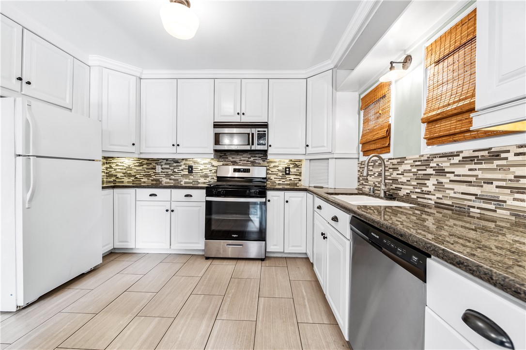 2109 Chestnut Avenue Long Beach, CA 90806 - Photo 14 of 32 a kitchen with stainless steel appliances granite countertop a stove a sink and a refrigerator