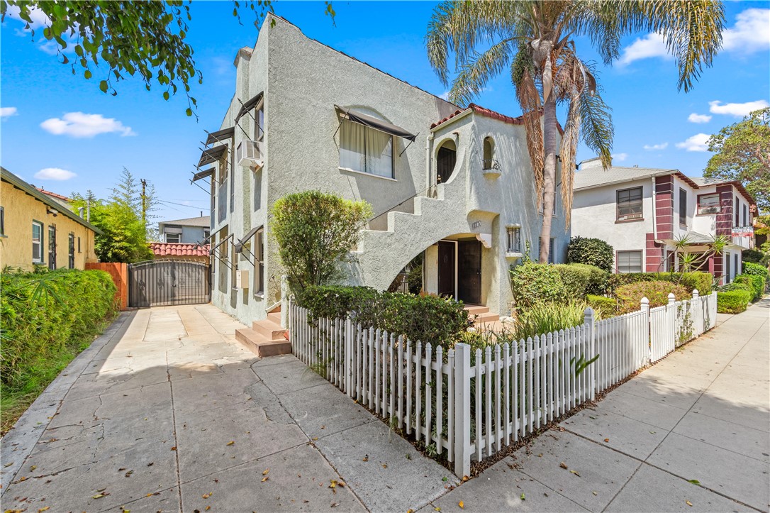 2109 Chestnut Avenue Long Beach, CA 90806 - Photo 2 of 32 a view of a white house with iron fence
