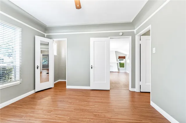 a spacious bathroom with a granite countertop double vanity sink a mirror and a