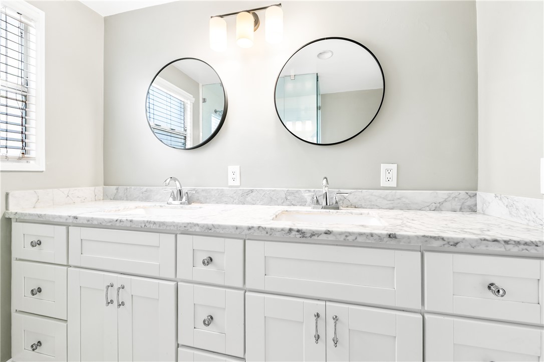 2109 Chestnut Avenue Long Beach, CA 90806 - Photo 28 of 32 a bathroom with a granite countertop double vanity sinks and a mirror