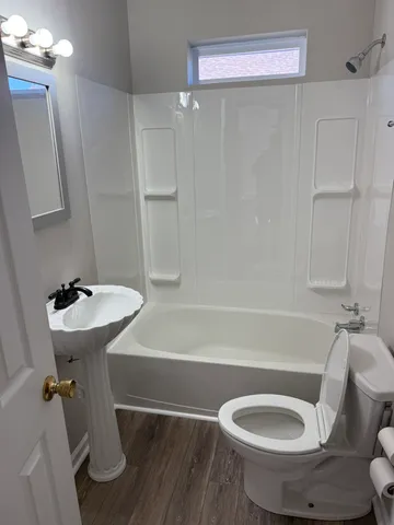 a bathroom with a sink a toilet and bathtub