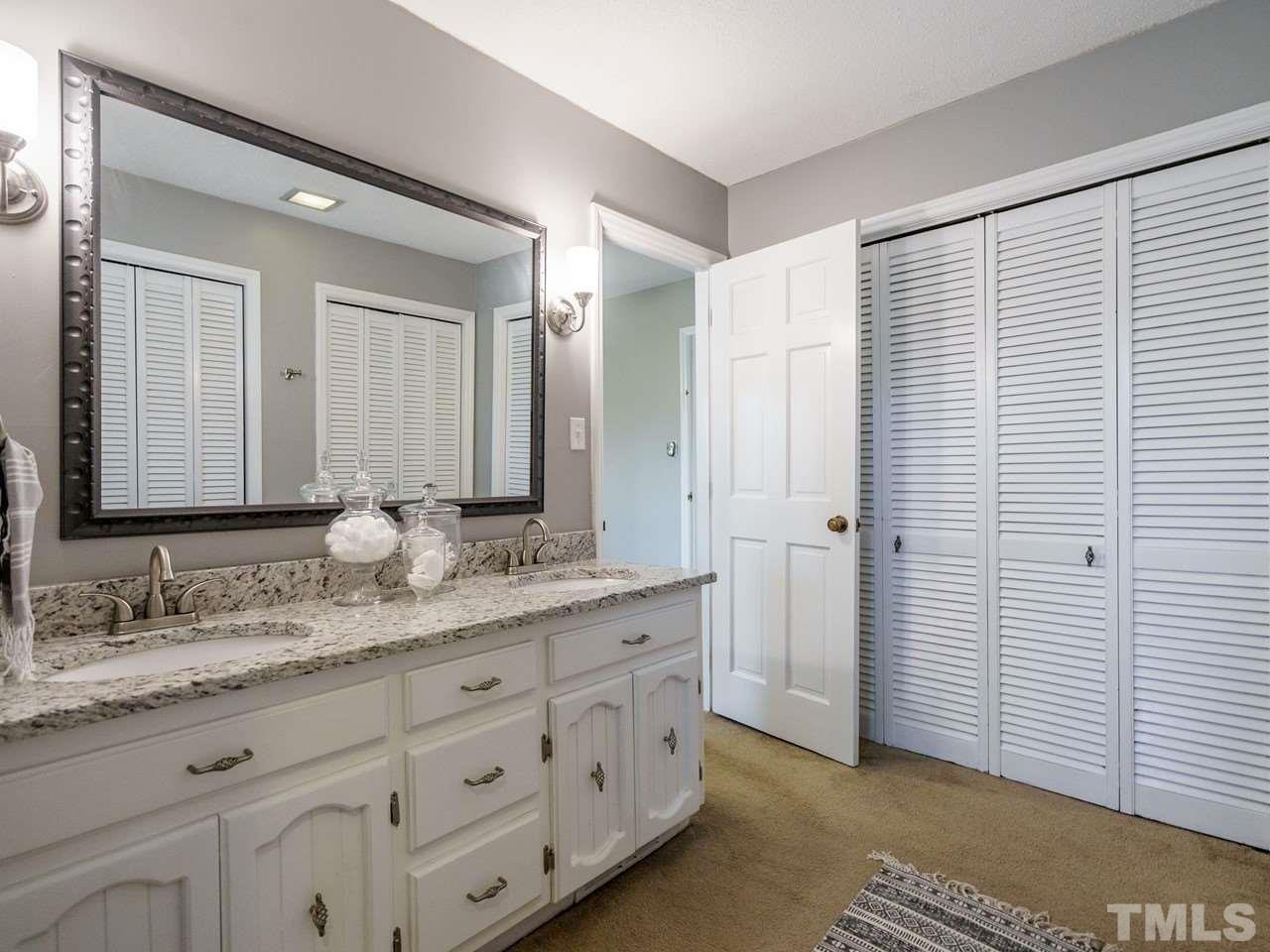 4109 Oak Park Road Raleigh, NC 27612 - Photo 16 of 28 a bathroom with a granite countertop sink and a mirror