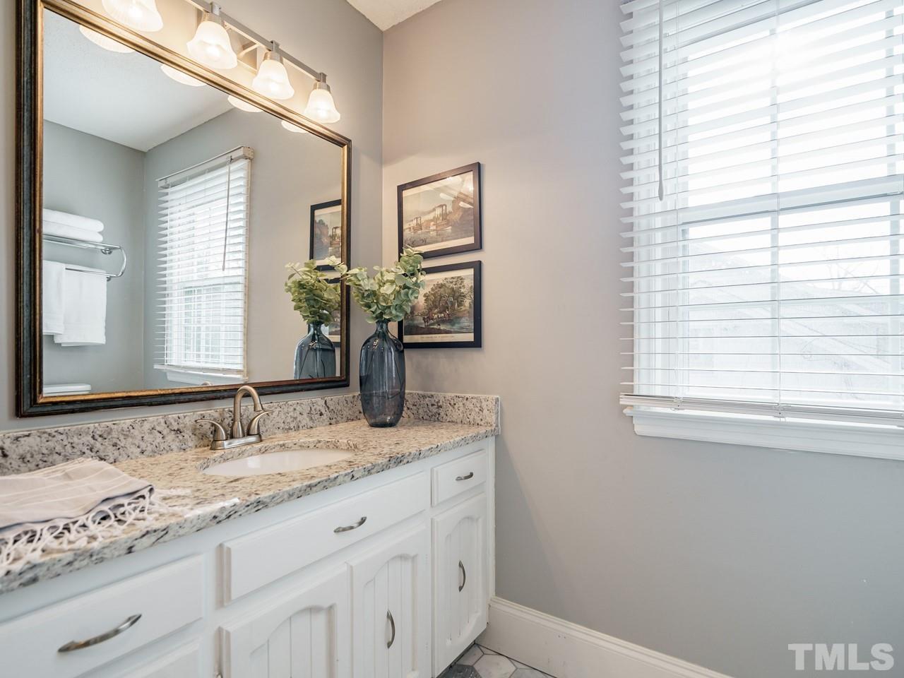 4109 Oak Park Road Raleigh, NC 27612 - Photo 18 of 28 a bathroom with a granite countertop sink and a mirror