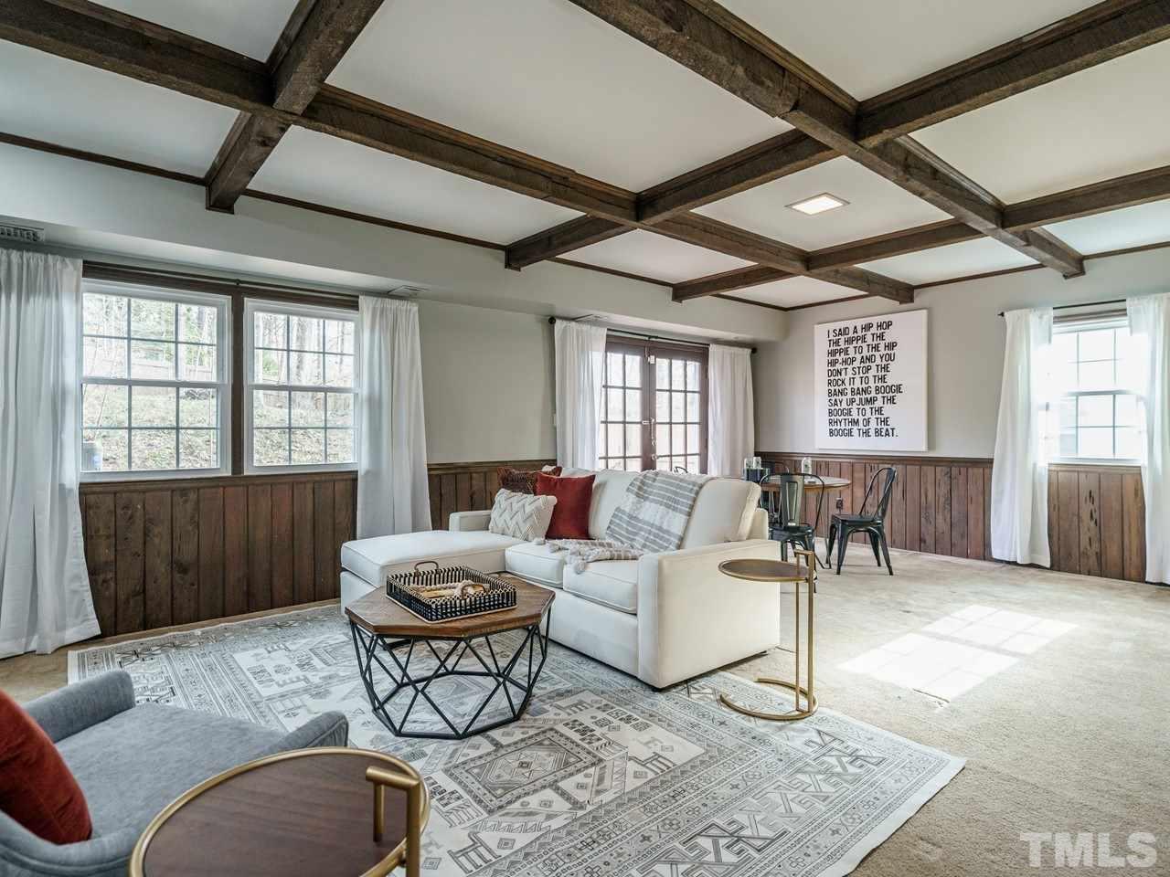4109 Oak Park Road Raleigh, NC 27612 - Photo 20 of 28 a living room with furniture a table and wooden floor