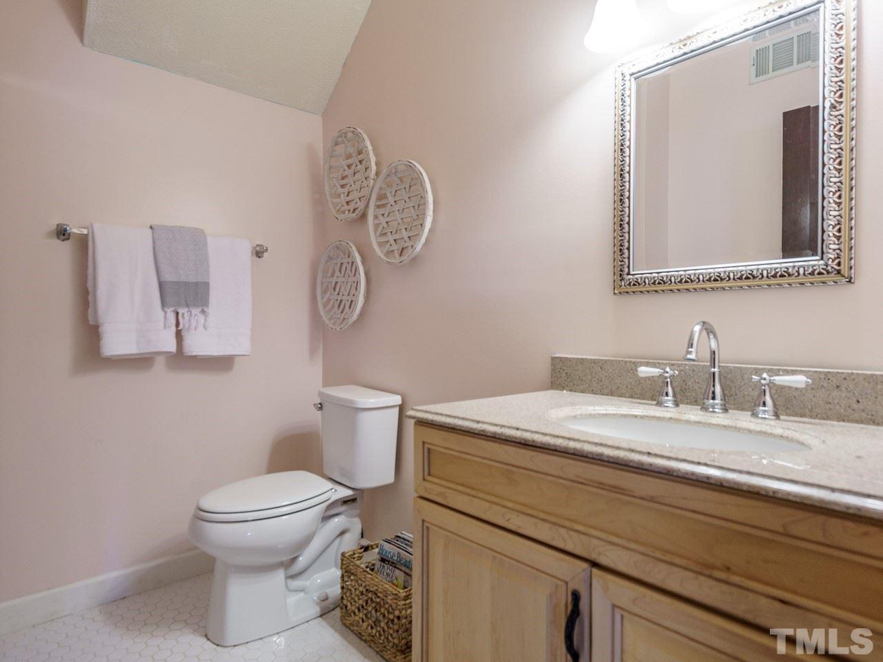 4109 Oak Park Road Raleigh, NC 27612 - Photo 26 of 28 a bathroom with a granite countertop toilet sink and mirror