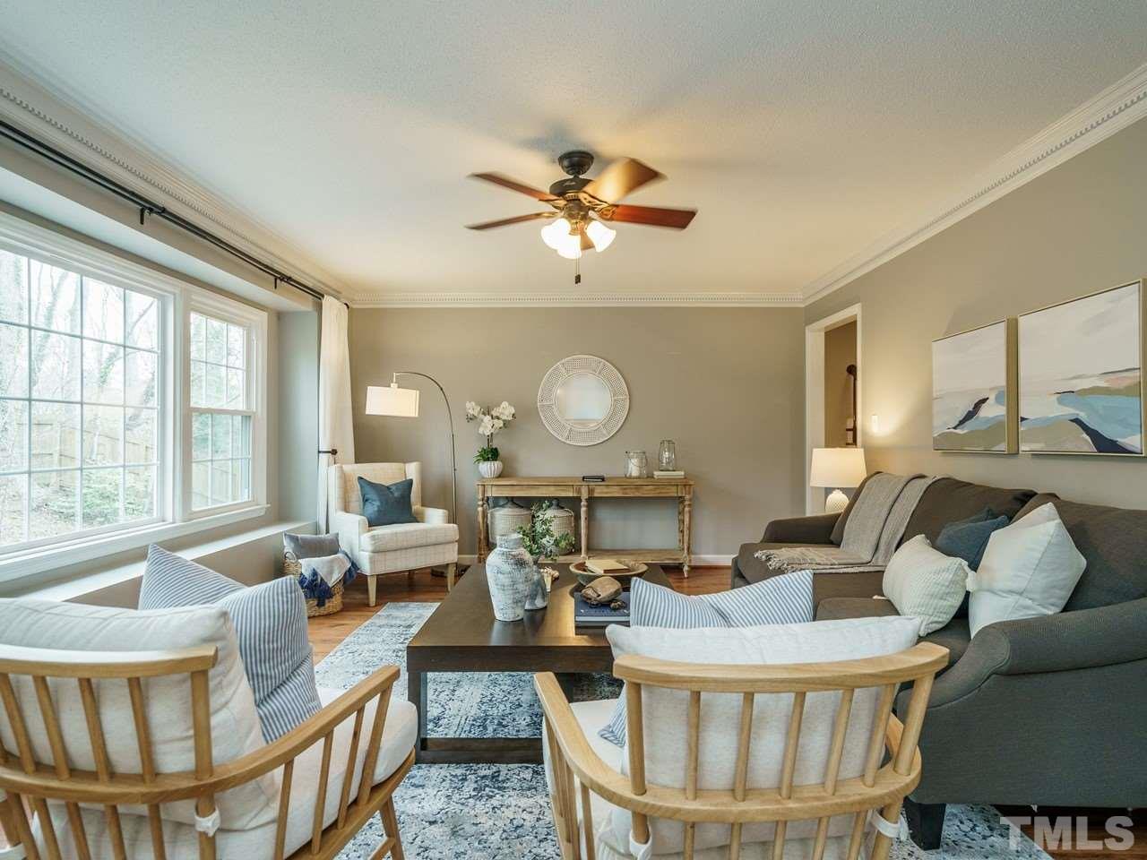 4109 Oak Park Road Raleigh, NC 27612 - Photo 5 of 28 a living room with furniture a large window and a chandelier