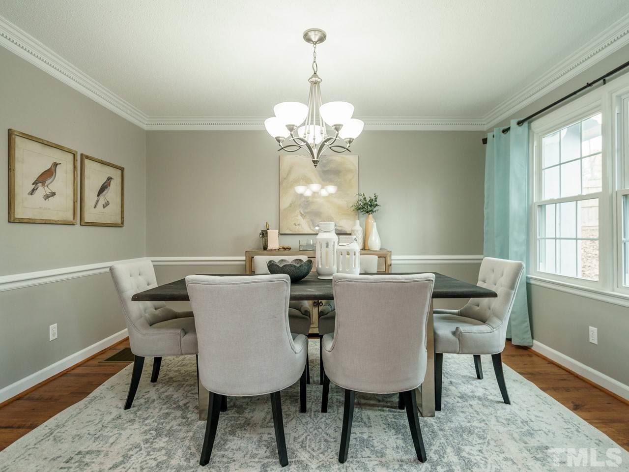 4109 Oak Park Road Raleigh, NC 27612 - Photo 6 of 28 a view of a dining room with furniture a chandelier and wooden floor
