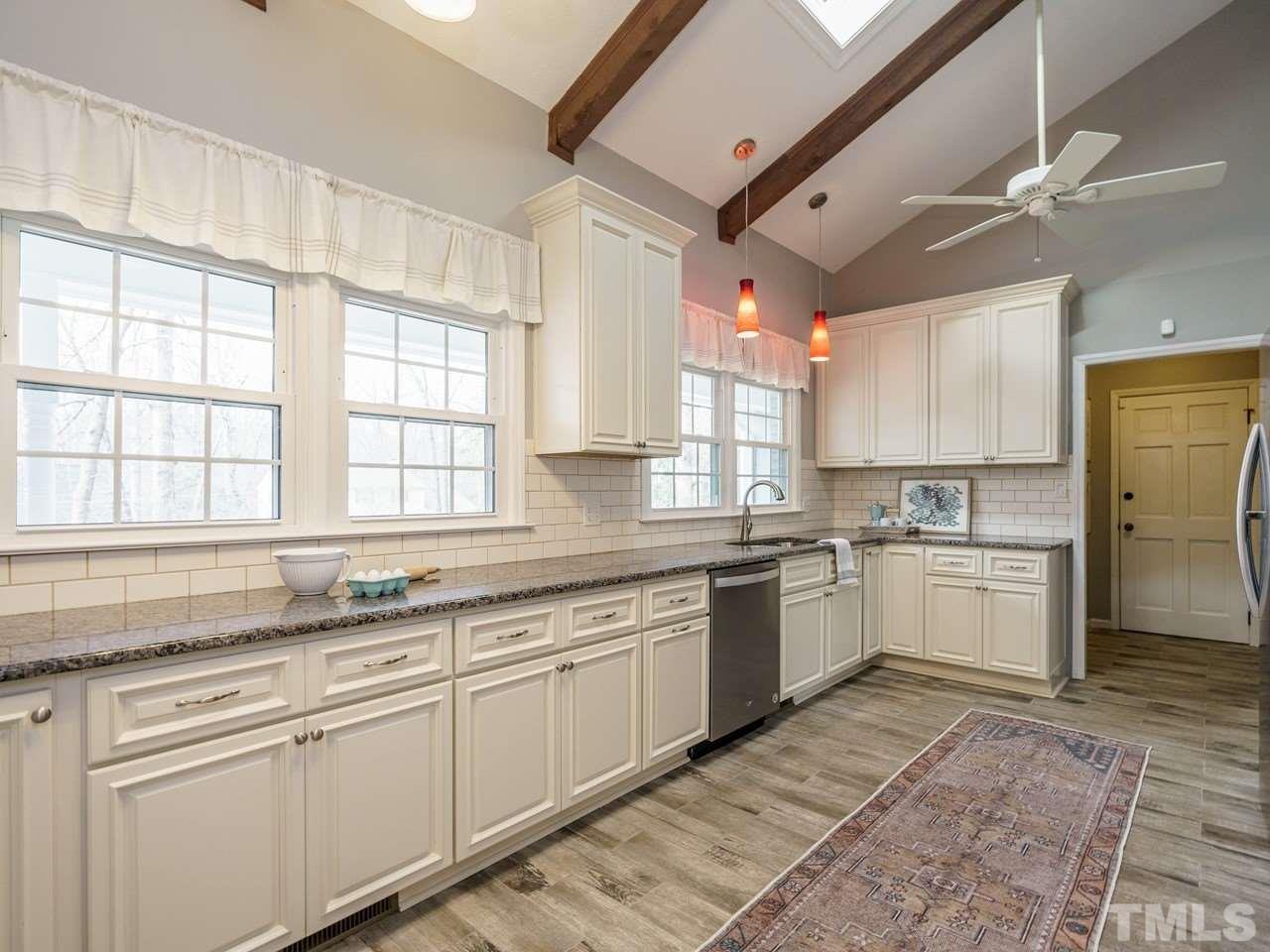 4109 Oak Park Road Raleigh, NC 27612 - Photo 8 of 28 a kitchen with a sink cabinets and window