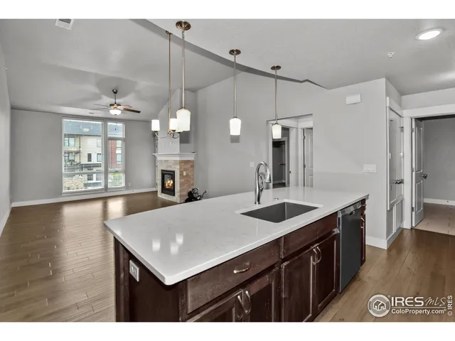 a kitchen with a sink a counter space and stainless steel appliances