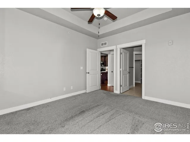 a view of a room with ceiling fan and entryway