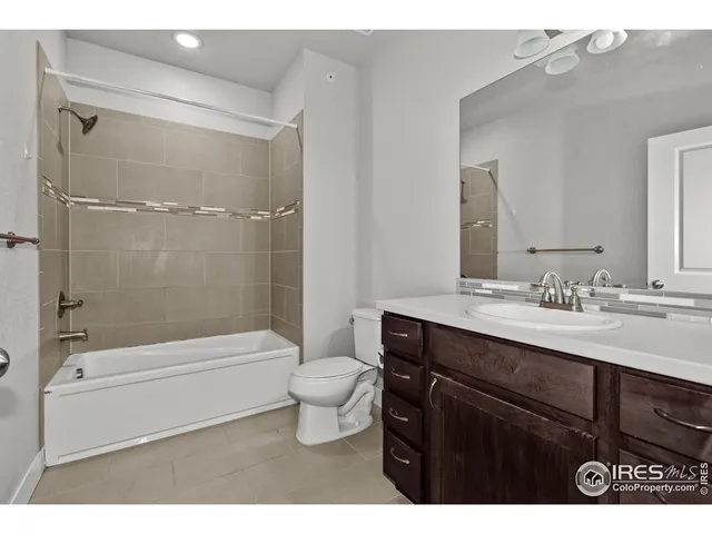 a bathroom with a sink toilet a mirror and shower
