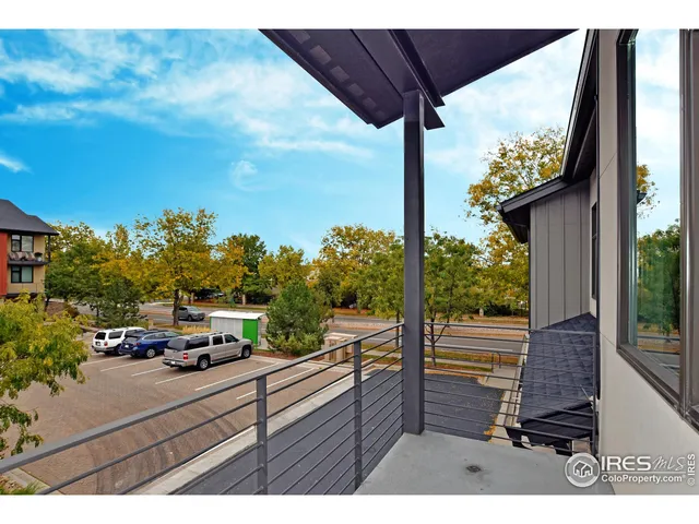 a view of a street with an outdoor seating