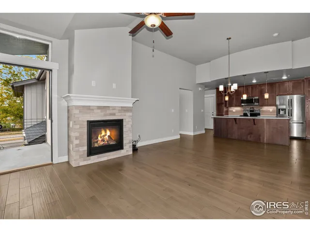a view of a kitchen and a fireplace with wooden floor