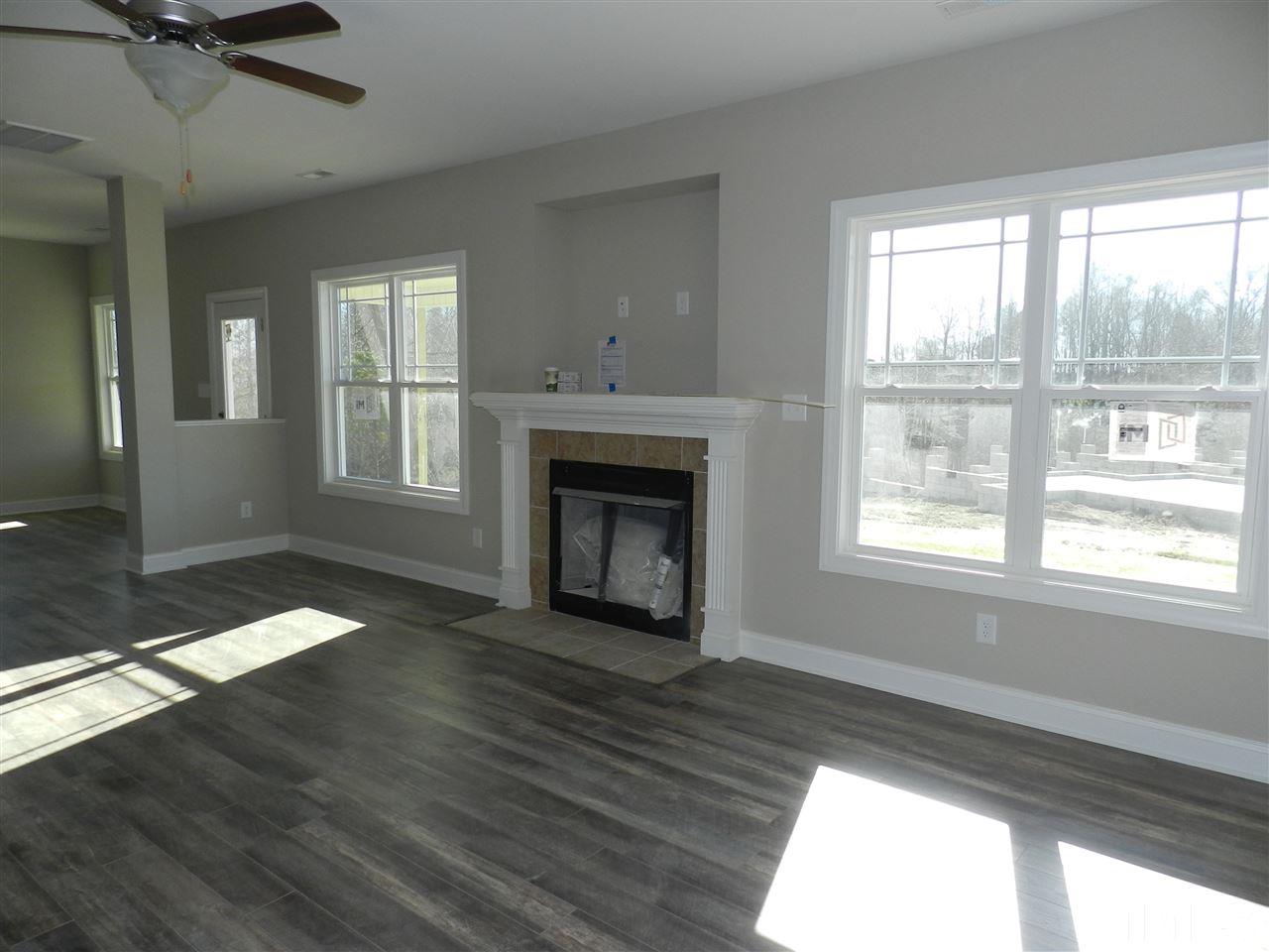 19 Labradoodle Court Garner, NC 27529 - Photo 4 of 9 a view of an empty room with wooden floor and a window