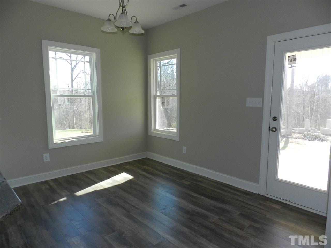 19 Labradoodle Court Garner, NC 27529 - Photo 8 of 9 a view of an empty room with wooden floor and a window