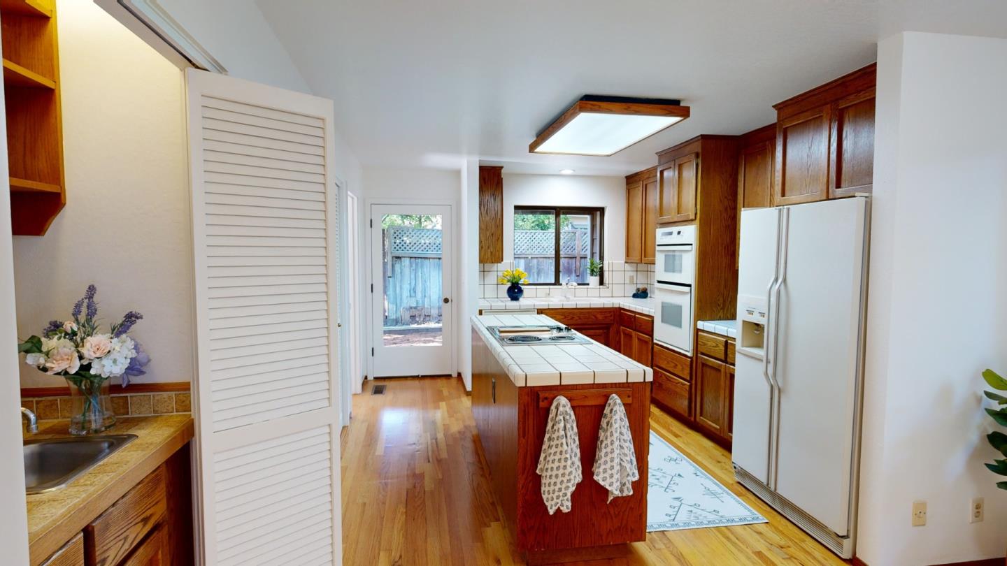 4493 Merlin Way Soquel, CA 95073 - Photo 11 of 52 a hallway with dining room and wooden floor