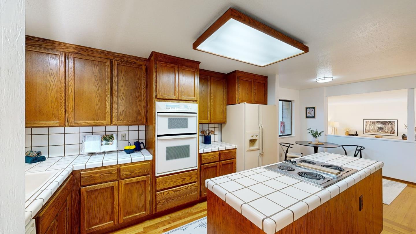 4493 Merlin Way Soquel, CA 95073 - Photo 13 of 52 a kitchen with stainless steel appliances granite countertop a sink stove and refrigerator