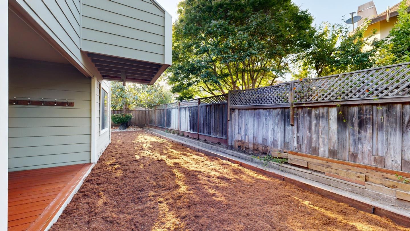 4493 Merlin Way Soquel, CA 95073 - Photo 27 of 52 a view of a backyard with a large tree and wooden fence