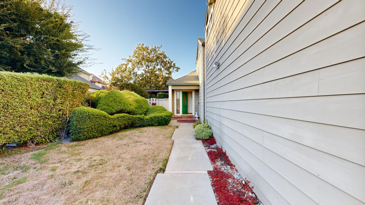4493 Merlin Way Soquel, CA 95073 - Photo 30 of 52 a front view of a house with a yard and potted plants