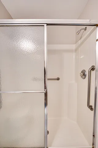 a bathroom with a glass shower door