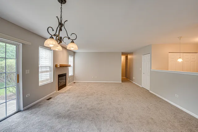 a view of empty room with windows and fireplace