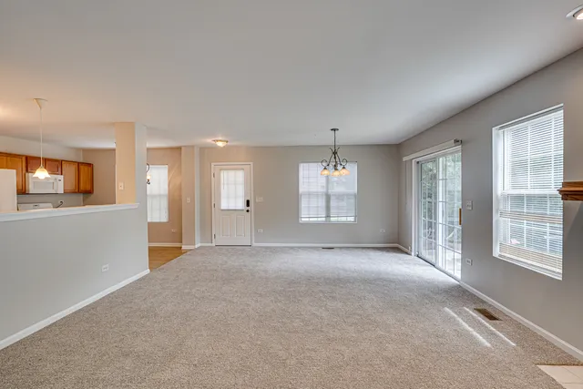a view of a livingroom with an empty space and a window
