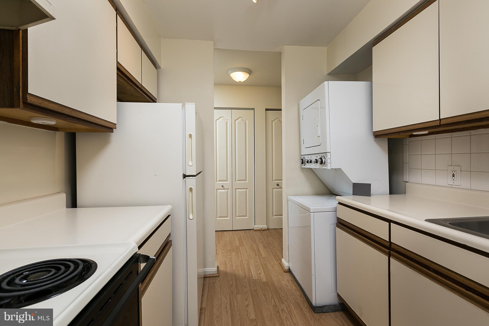 8390 Montgomery Run Road, Unit D Ellicott City, MD 21043 - Photo 6 of 19 Stacked washer & dryer in unit