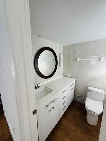 a bathroom with a toilet a sink and a mirror