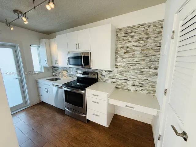 a kitchen with a stove microwave and a refrigerator