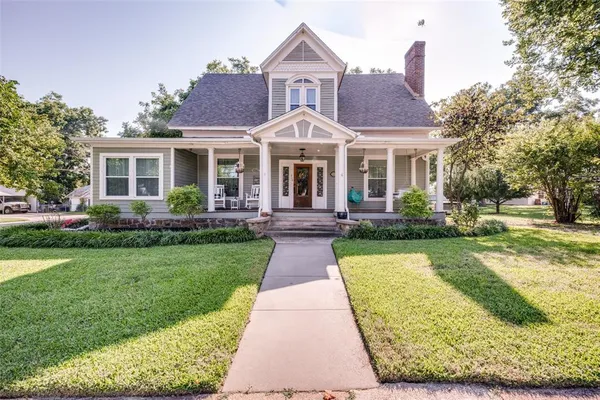 a front view of a house with yard and green space