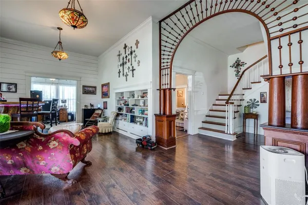 a living room with lots of furniture and stairs
