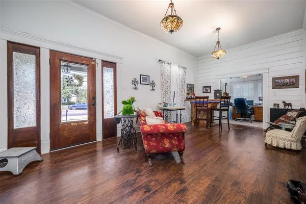 a living room with furniture and wooden floor