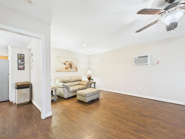 a living room with furniture and a lamp