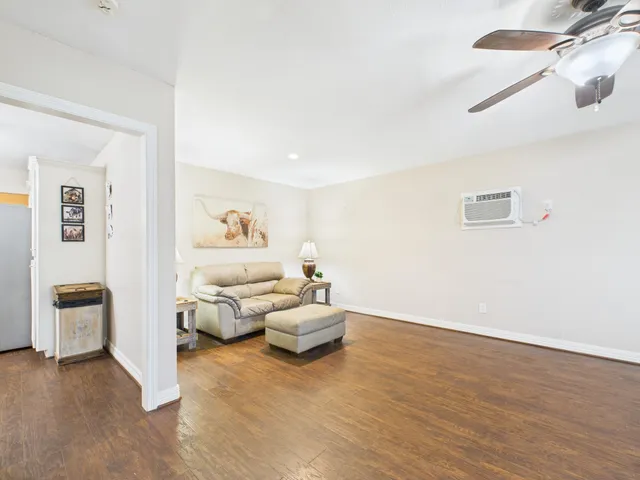 a living room with furniture and a lamp
