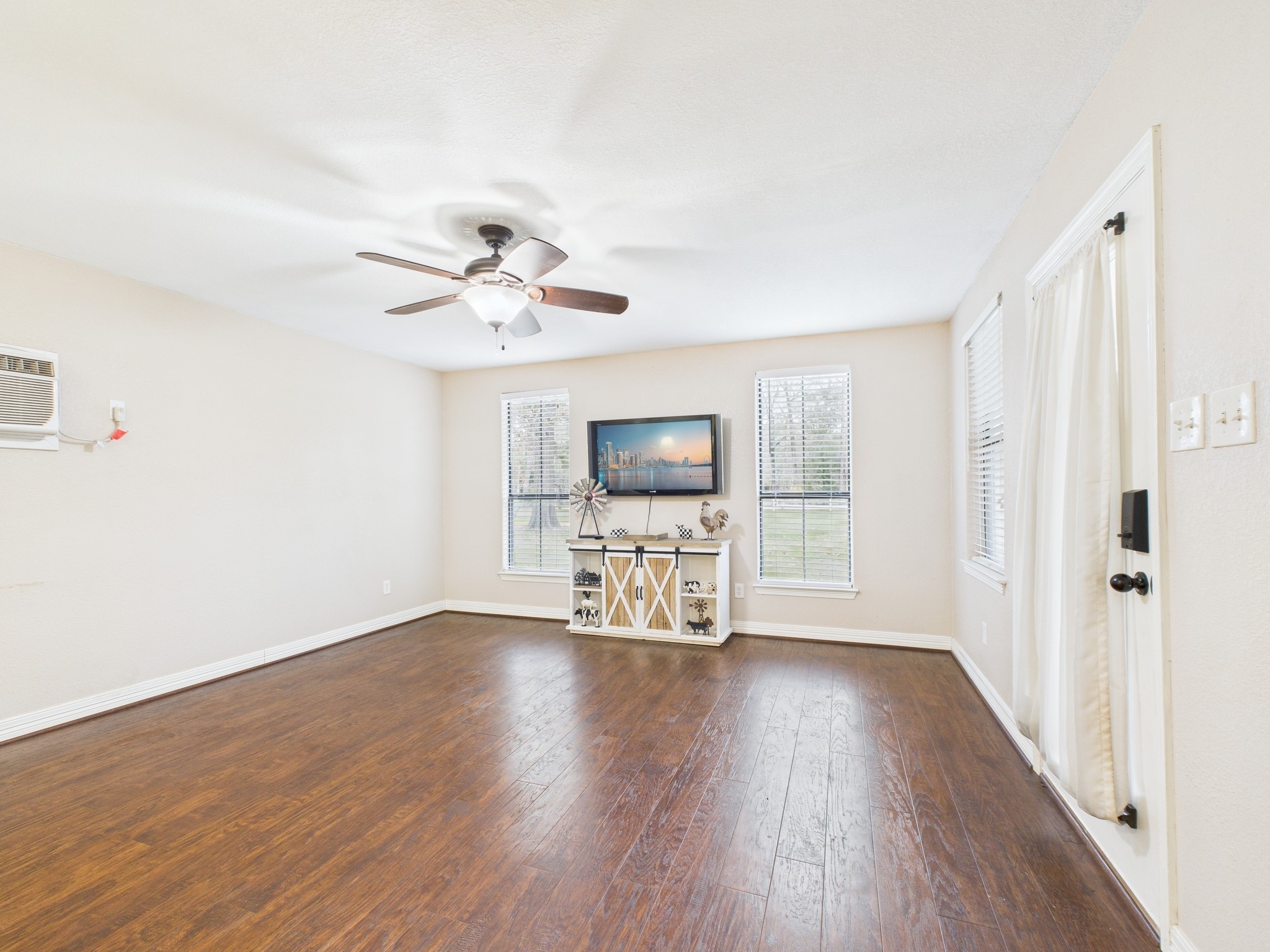 15802 Firetower Road, Unit A Conroe, TX 77306 - Photo 5 of 17 wooden floor in an empty room with a window