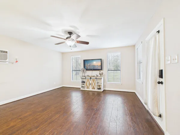 wooden floor in an empty room with a window