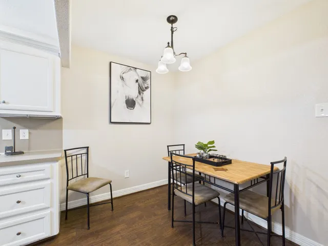a view of a dining room with furniture and wooden floor