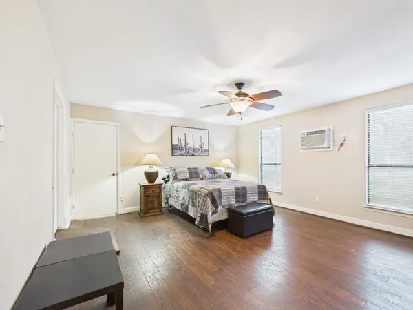 a spacious bedroom with a bed and a chandelier