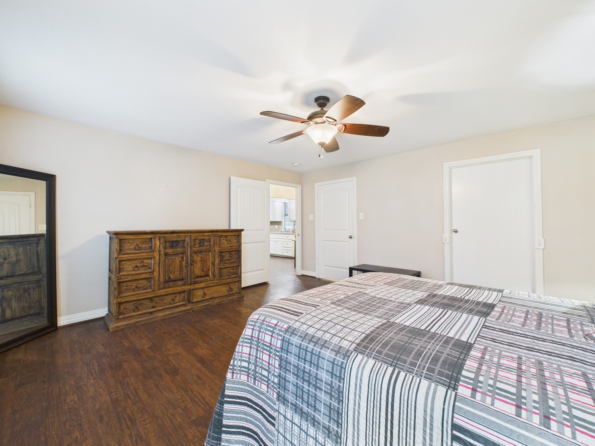 15802 Firetower Road, Unit A Conroe, TX 77306 - Photo 10 of 17 a spacious bedroom with a bed a dresser and a chandelier