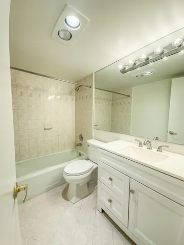 a bathroom with a double vanity sink toilet mirror and shower