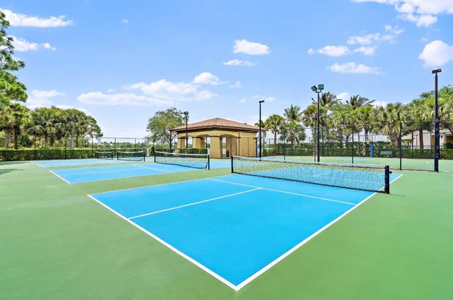 a room with lots of tables a large window and chairs