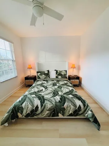 a bathroom with a double vanity sink a large mirror and a shower