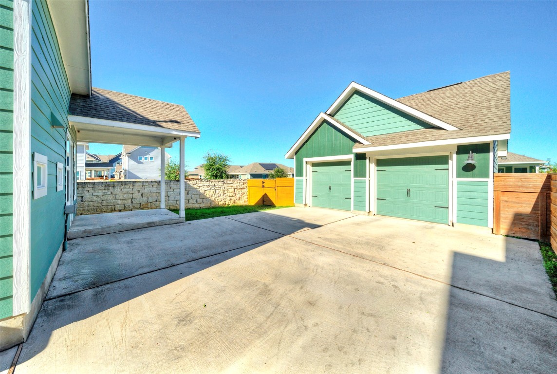 201 Rioja Kyle, TX 78640 - Photo 18 of 21 a view of yellow house with a big yard and potted plants